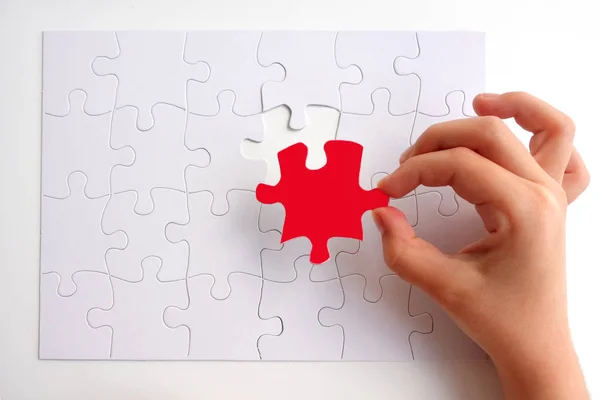 Young girl placing the last puzzle piece — Stock Photo, Image