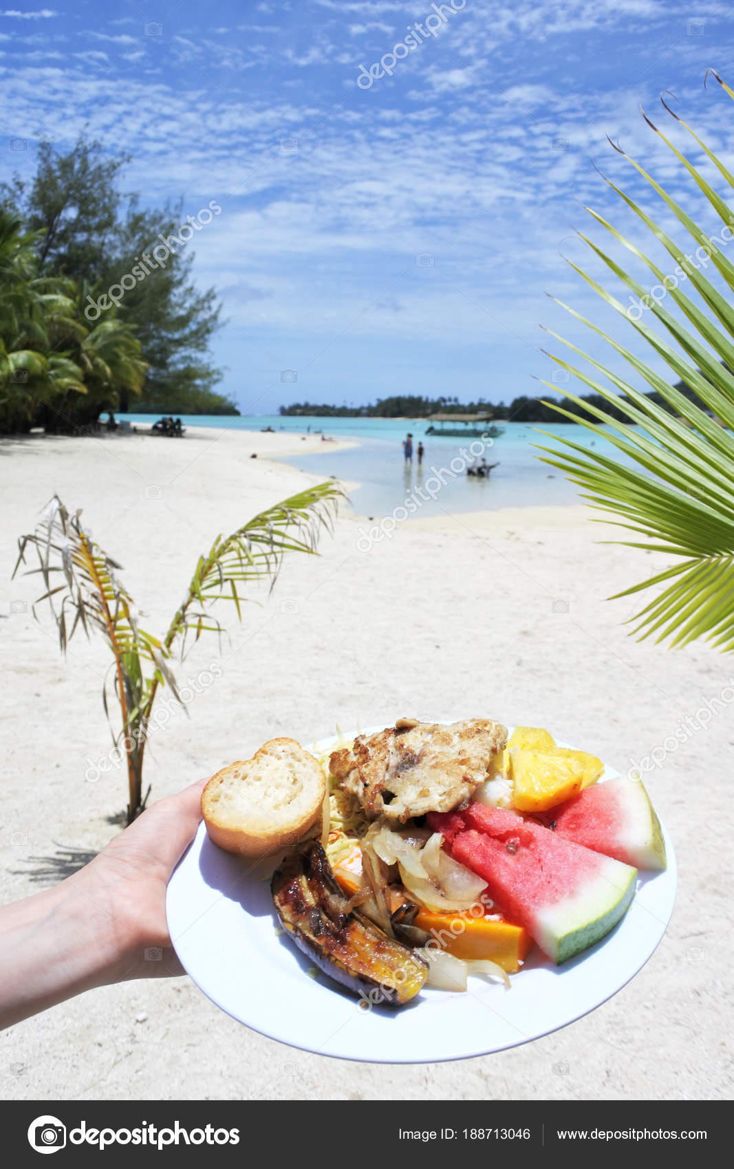 Woman hand carry traditional tropical food in Muri lagoon Raroto