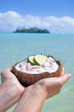 Woman holds Ceviche Dish served in a coconut shell against a isl clipart