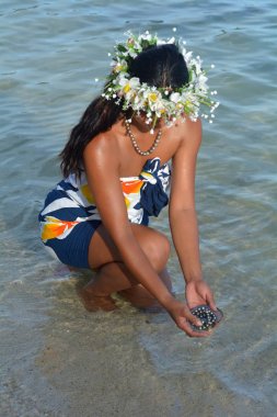 Polynesian Cook Islander woman holding Tahitian Black Pearls in  clipart