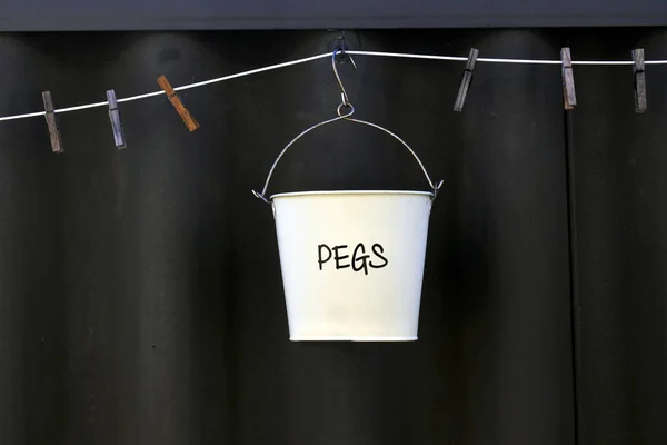 Pegs bucket on washing line — Stock Photo, Image