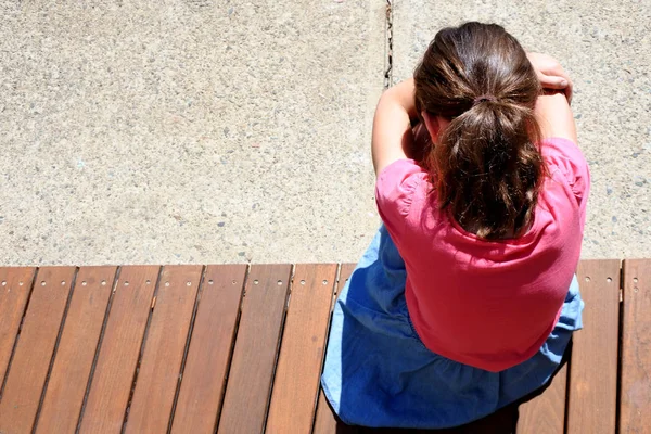 Above view  of sad young girl covering her face and crying in sc — Stock Photo, Image