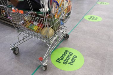 PERTH - MAR 31 2020:Social distancing marks on supermarket floor intended to stop spread of the contagious Coronavirus.Since COVID-19 outbreak started 786,228 got infected and 37,820 die worldwide. clipart