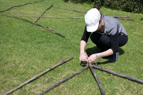 Young Adult Woman Tying Knots Pieces Wooden Poles Green Grass — Stock Photo, Image