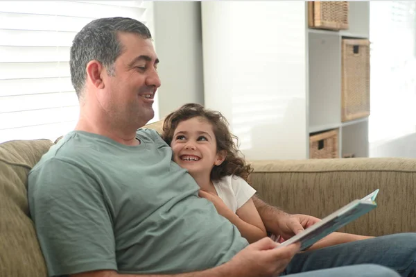 Father Age Reading Book His Daughter Age Home Living Room — Stock Photo, Image