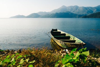 Montenegro mountain sunny landscape. Beautiful photo of nature.  The photo of boat on the lake