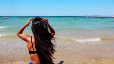 Young Woman Sitting On The Beach Sand And Looking Sea Footage.