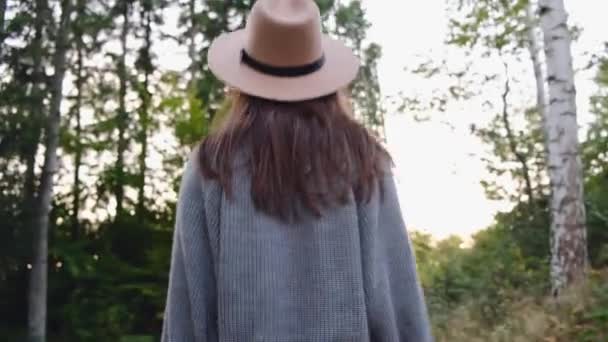 Camera Follows Young Woman Hat Walks Forest Raises Arms Air — Stockvideo