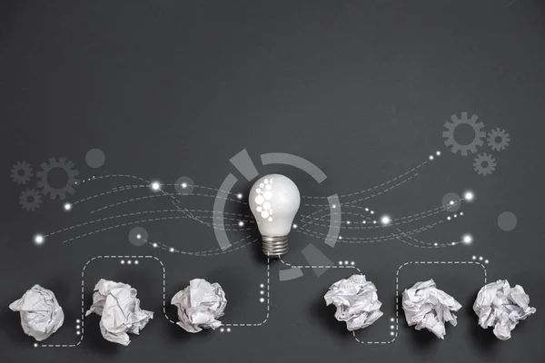 Innovation concept. Crumpled office paper and white light bulb future technologies and network connection on virtual interface background, innovative technology in science and communication concept