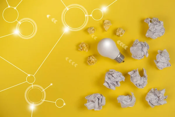 Creativity inspiration, great business idea concept with white light bulb and paper crumpled ball on yellow background. Flat lay, top view, copy space — 图库照片