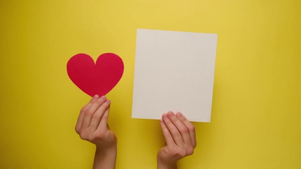 Female Hands Holding Red Paper Heart White Blank Yellow Paper — Stock Video