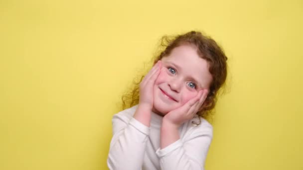 Happy Child Smiles Keeps Hand Cheek Romantic Expression Remembers Something — Stock Video