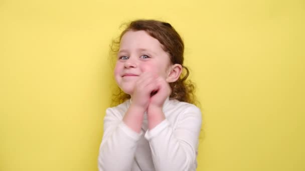 Delighted Relaxed Child Smiles Broadly Has Sensual Look Keeps Hand — Stock Video