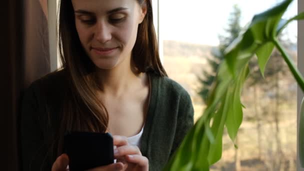 Close Young Woman Relax Sitting Window Sill Home Using Cell — Vídeo de Stock