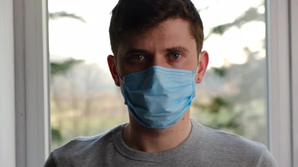 Close Portrait Young Serious Man Medical Sterile Face Mask Sitting — Stock Video