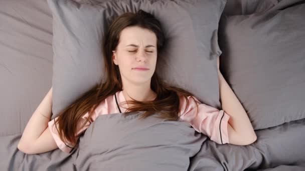 Woman Lying Bed Covering Head Pillow Because Too Loud Annoying — Stock Video