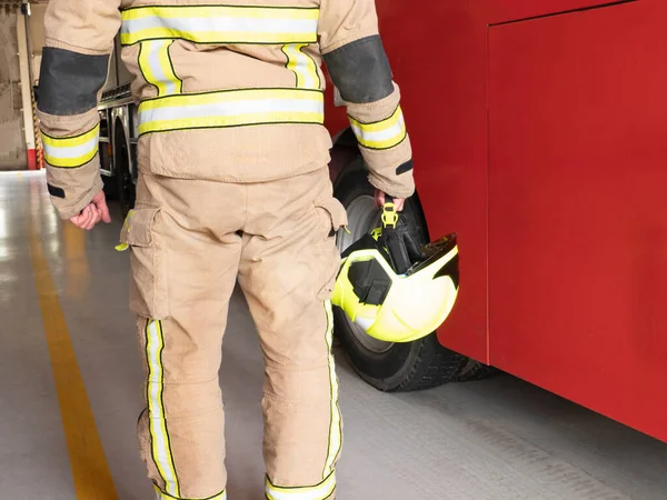 Firefighter Carries Helmet His Hand Next Red Truck — Stock Photo, Image