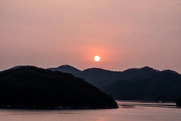 Sunrise denizden ve turuncu gökyüzü ile adalar