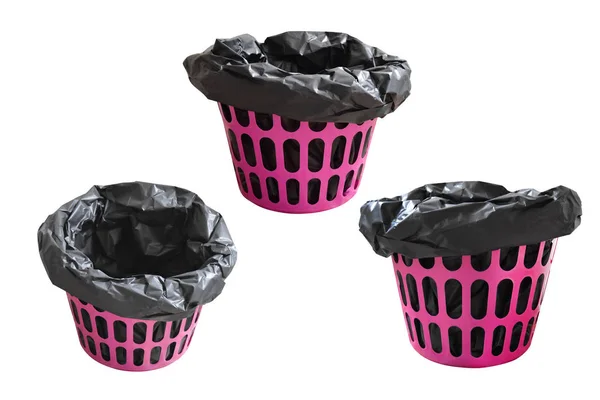 Roze garbage bin mand met lege zwarte tas, geïsoleerd op wit — Stockfoto