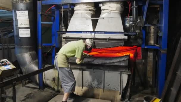 Gets working hot glass from the furnace.A furnace for tempering glass. — Stock Video