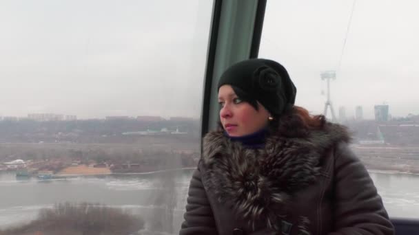 Mujer cabalga en el teleférico y mirando por la ventana . — Vídeos de Stock