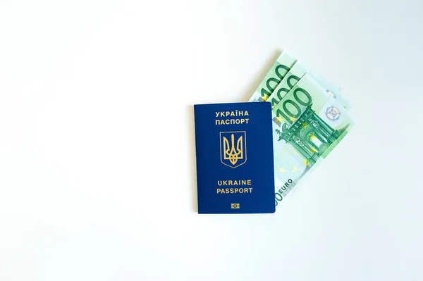 Pasaporte de Ucrania con Euro Bills dentro. Sobre un fondo blanco con monedas de relleno . —  Fotos de Stock