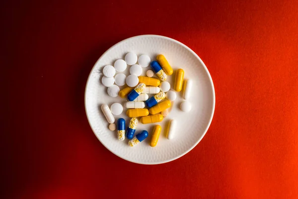 Different tablets, pills, medications drugs on bronze background — Stock Photo, Image