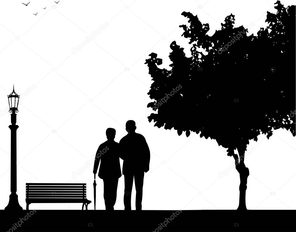 Lovely retired elderly couple walking with umbrella in park
