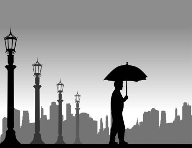 Şemsiyenin altına sokakta yürüyen genç adam