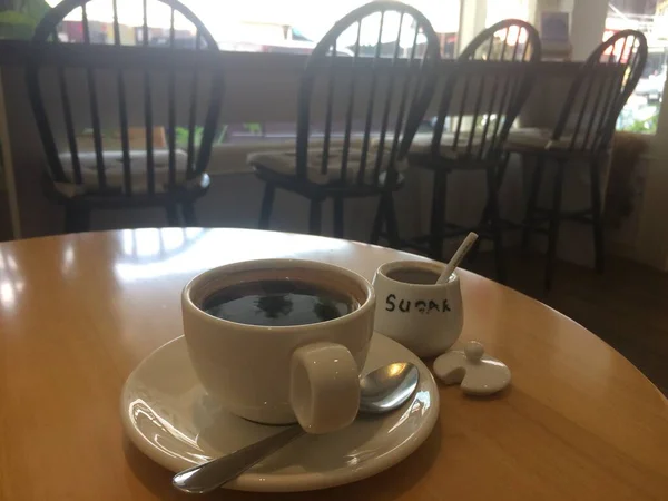 Hot Americano coffee with sugar for added sweetness