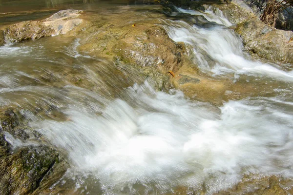 Slow motion waterfalls running at a stream
