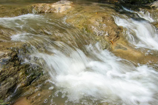 Slow motion waterfalls running at a stream