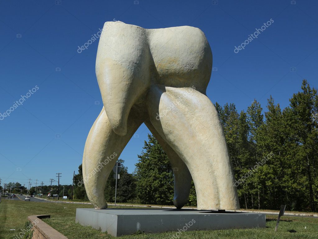 HAMILTON, NEW JERSEY - SEPTEMBER 25, 2016: Tooth sculpture by artist Seward Johnson in Hamilton, NJ. John Seward Johnson II  is an American artist known for his trompe l'oeil painted bronze statues