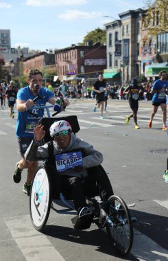  New York City Marathon wheelchair division participants traverse 26.2 miles through all five NYC boroughs to the finish line in Central Park, Manhattan clipart