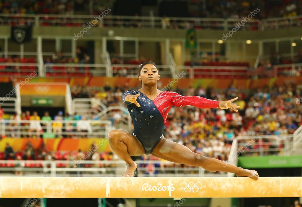 RIO DE JANEIRO, BRAZIL AUGUST 7, 2016: Olympic champion Simone Biles of United States competing on the balance beam at women's all-around gymnastics qualification at Rio 2016 Olympic Games