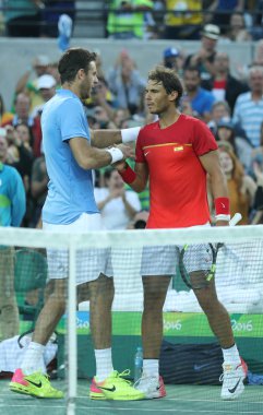 Juan Martin Del Potro of Argentina (L) and  Rafael Nadal of Spain after men's singles semifinal match of the Rio 2016 Olympic Games  clipart