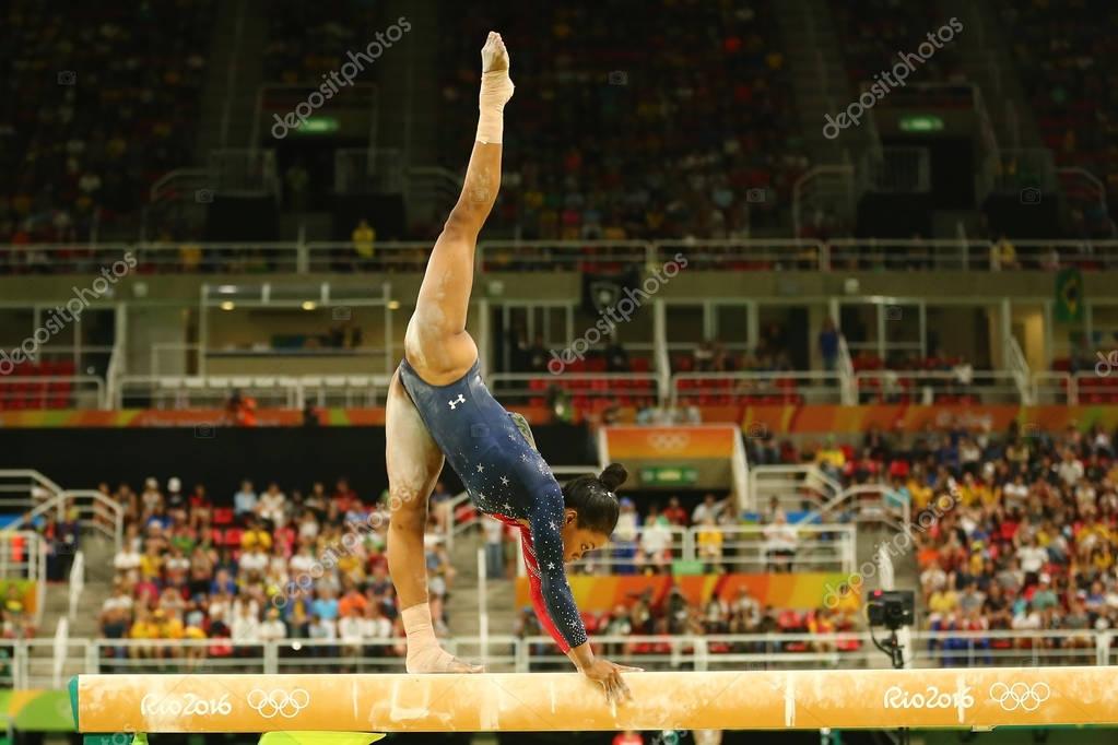 RIO DE JANEIRO, BRAZIL AUGUST 7, 2016: Olympic champion Gabby Douglas  of United States competes on the balance beam at women's all-around gymnastics qualification at Rio 2016 Olympic Games