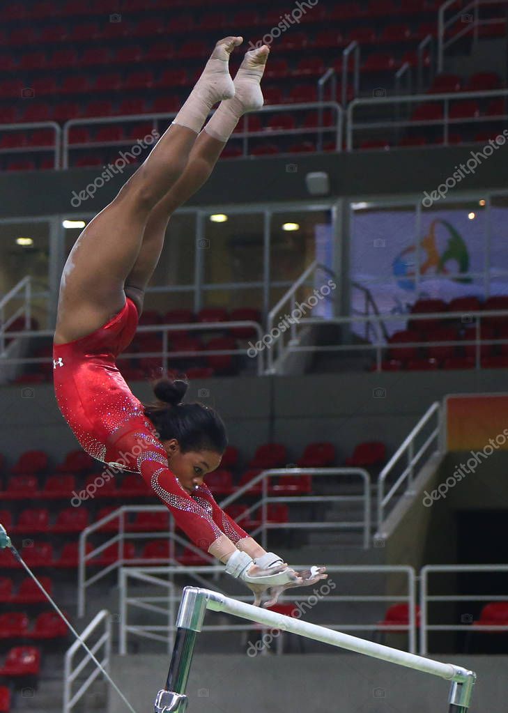 RIO DE JANEIRO, BRAZIL AUGUST 4, 2016: Olympic champion Gabby Douglas  of United States practices on the uneven bars before women's all-around gymnastics at Rio 2016 Olympic Games