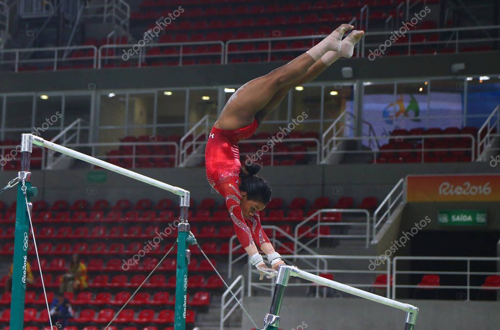 RIO DE JANEIRO, BRAZIL AUGUST 4, 2016: Olympic champion Gabby Douglas  of United States practices on the uneven bars before women's all-around gymnastics at Rio 2016 Olympic Games
