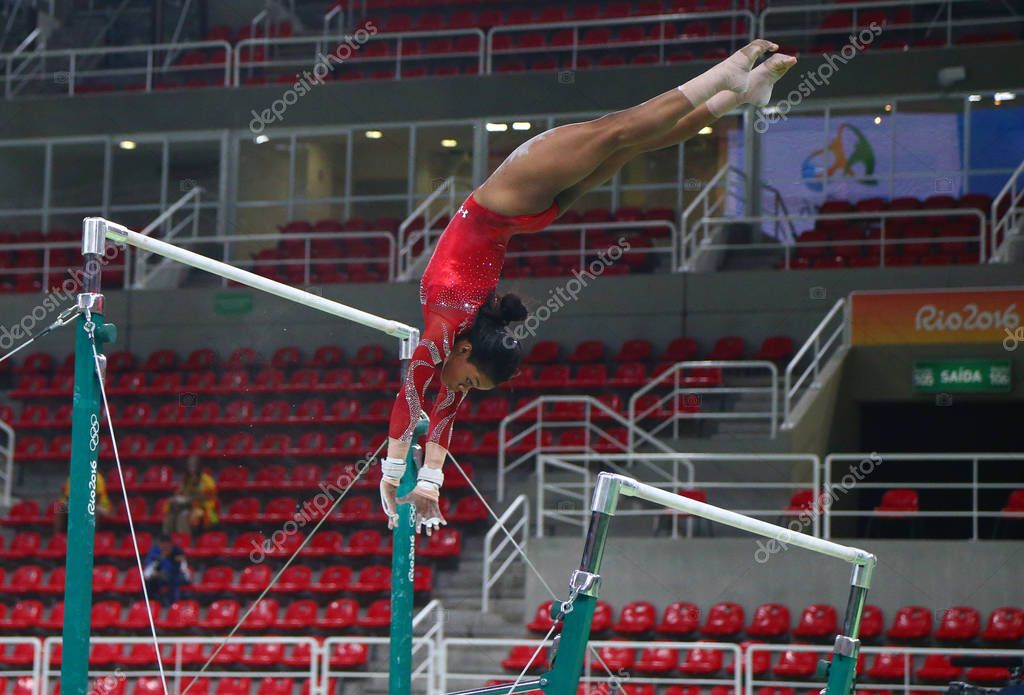 RIO DE JANEIRO, BRAZIL AUGUST 4, 2016: Olympic champion Gabby Douglas  of United States practices on the uneven bars before women's all-around gymnastics at Rio 2016 Olympic Games