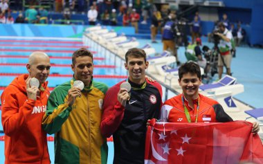  Laszlo Cseh HUN (L), Chad le Clos RSA , Michael Phelps USA and Joseph Schooling SGP during medal ceremony after Men's 100m butterfly of the Rio 2016 Olympics clipart