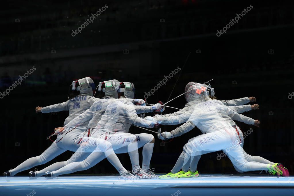 RIO DE JANEIRO, BRAZIL - AUGUST 13, 2016: Sofya Velikaya of Russia (L) and Mariel Zagunis of United States compete in the Women's Sabre Team of the Rio 2016 Olympic Games at Carioca Arena 3