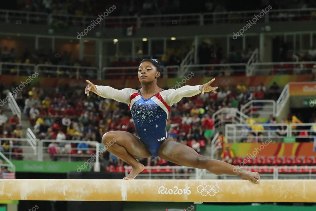 RIO DE JANEIRO, BRAZIL - AUGUST 11, 2016: Olympic champion Simone Biles of United States competes on the balance beam at women's all-around gymnastics at Rio 2016 Olympic Games