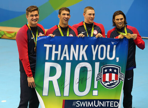 USA Men's 4x100m medley relay team Nathan Adrian(L), Michael Phelps, Ryan Murphy and Cory Miller celebrate victory at the Rio 2016 Olympic Games 