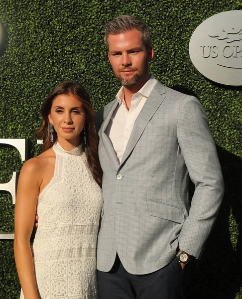 American real estate salesperson and reality television star Ryan Serhant (R) and Emilia Bechrakis attend US Open 2016 opening ceremony — Stock Photo, Image