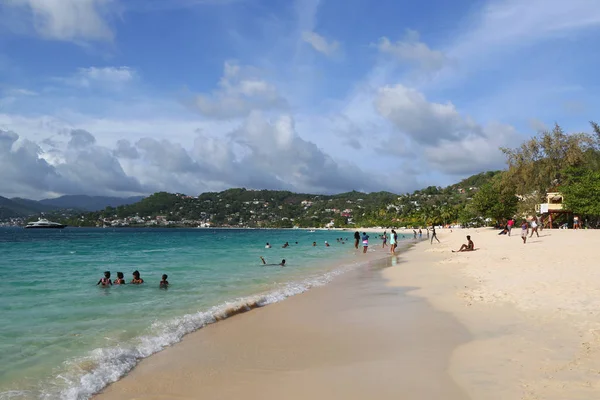 Local residents enjoy sunny day at Grand Anse Beach in Grenada. — Stock Photo, Image