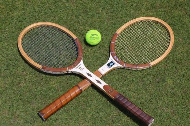 Vintage Tennis rackets and Slazenger Wimbledon Tennis Ball on grass tennis court clipart