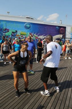  People dance on the Coney Island Boardwalk in Brooklyn clipart