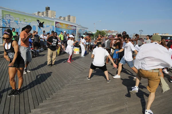Menschen tanzen auf der Strandpromenade der Kegelinsel in Brooklyn — Stockfoto