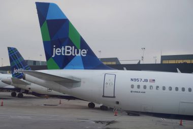 JetBlue plane on tarmac at John F Kennedy International Airport in New York  clipart